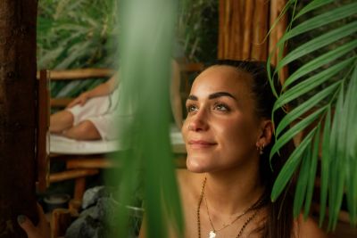 Femme dans un sauna avec des palmiers